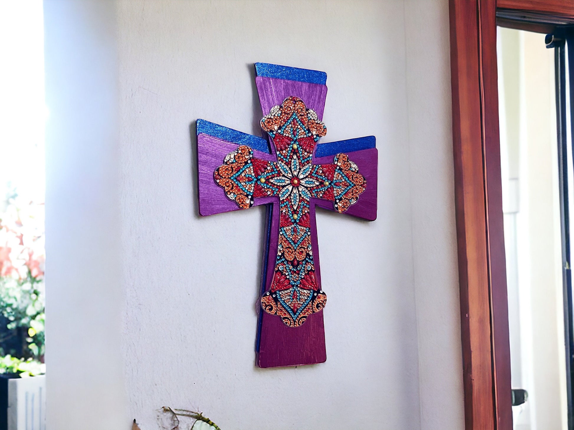 Handmade decorated Christian wall cross hanging with intricate designs and religious symbols, suitable for home or church decor.
