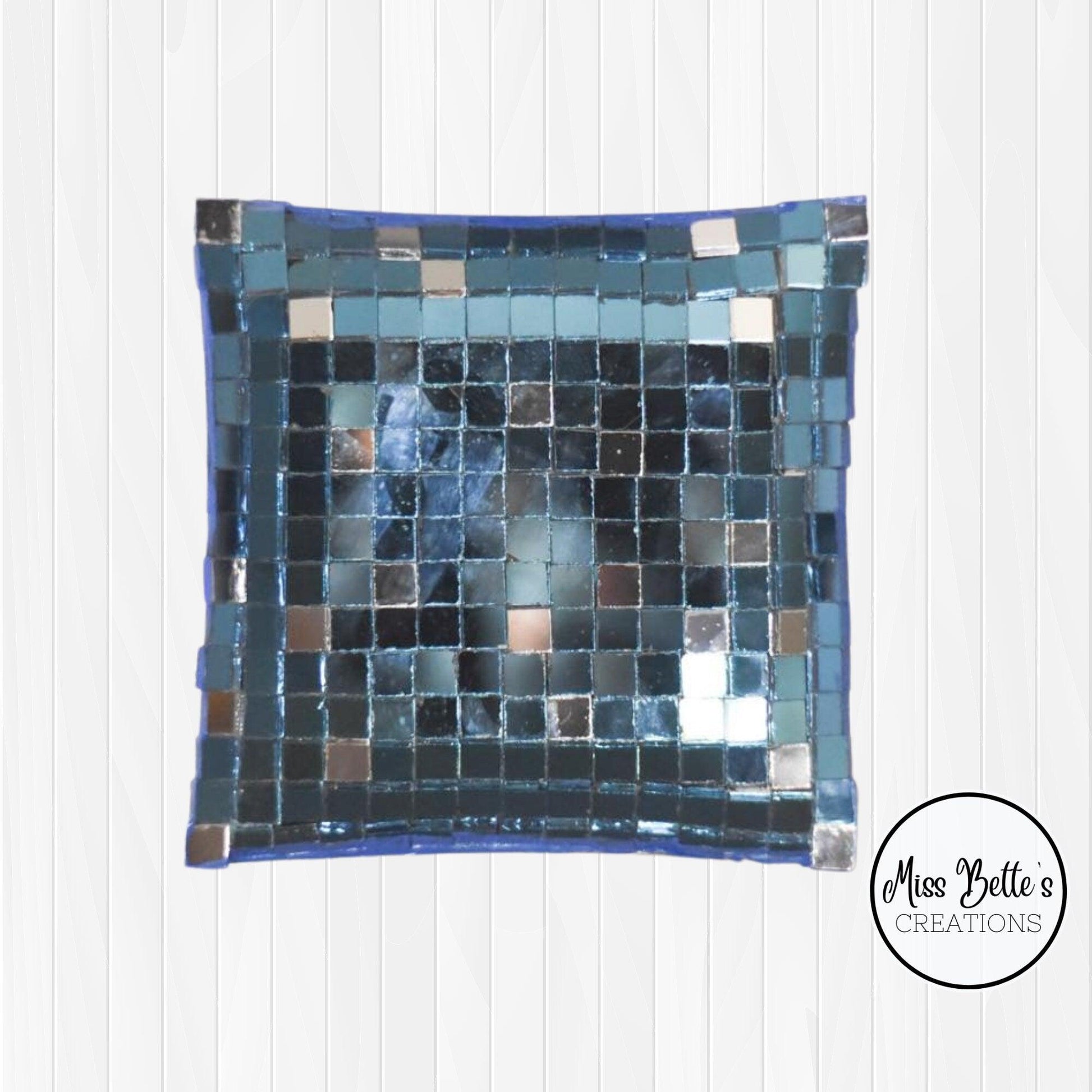 Handcrafted mosaic mirror glass dish with colorful, intricate tile patterns, perfect for decorative display or serving.