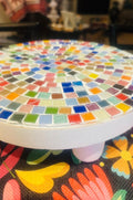 White rainbow mosaic plant stand, handcrafted with colorful tile design, perfect for displaying potted plants in a stylish home.
