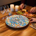 Colorful handcrafted round rainbow mosaic plant stand with sturdy base, perfect for displaying potted plants in indoor or outdoor spaces.
