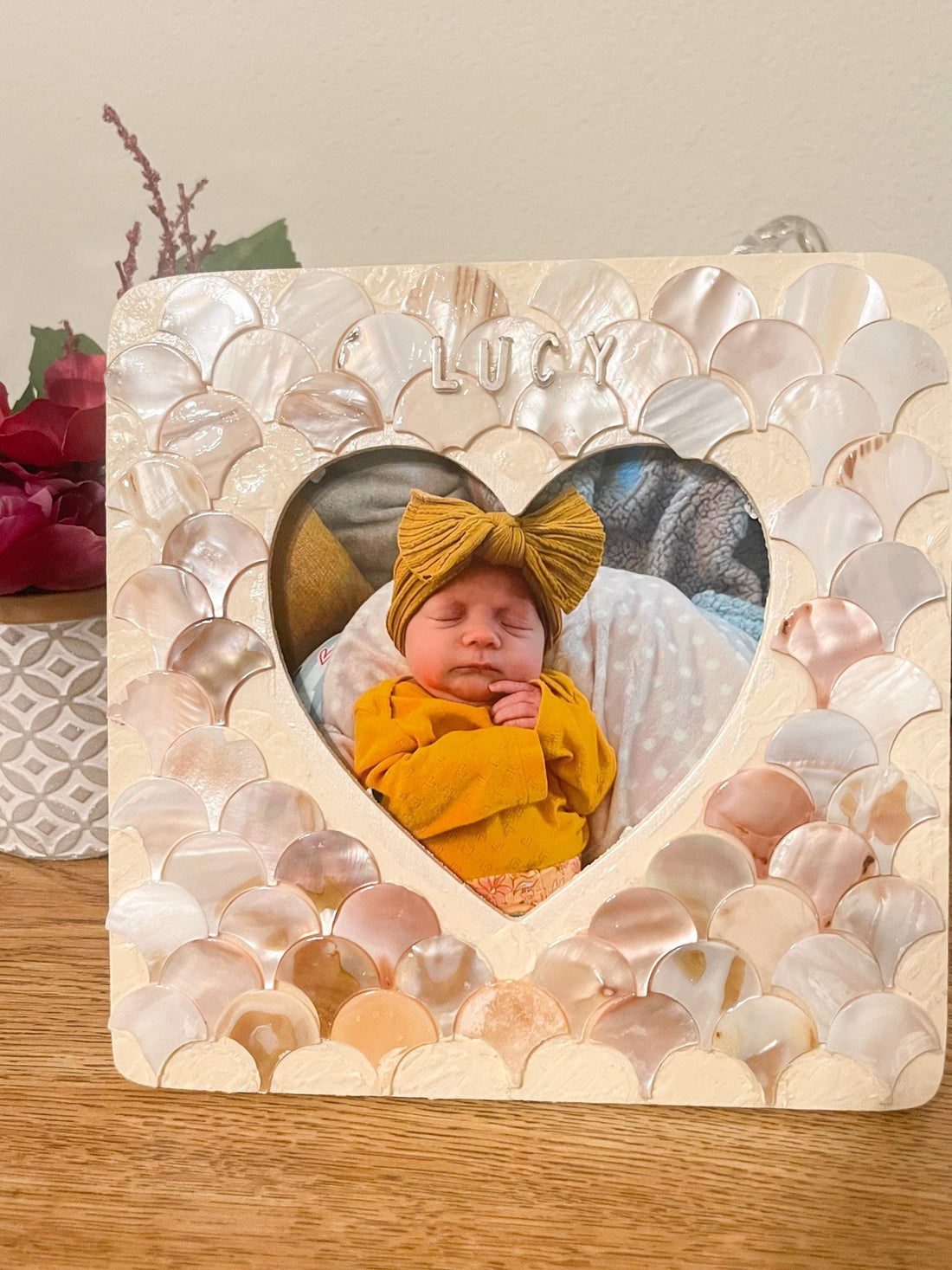 Mother of Pearl personalized photo frame with decorative border, featuring a custom engraving area, displayed on a neutral background.