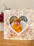 Mother of Pearl personalized photo frame with decorative border, featuring a custom engraving area, displayed on a neutral background.