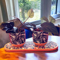 Rustic ceramic trivet, spoon rest, or plant stand with a textured design, ideal for kitchen or tabletop use.
