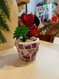 Handcrafted broken china heart mosaic planter with colorful ceramic pieces, suitable for indoor or outdoor decorative plant display.
