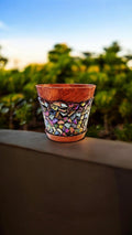 Handcrafted iridescent mosaic planter with colorful glass tiles for indoor or outdoor plant display.