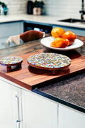 Handcrafted round rainbow mosaic plant stand with colorful ceramic tiles, designed to elevate indoor plants with artistic style.