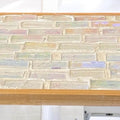 Rose quartz and slate mandala mosaic wall art featuring intricate geometric patterns and vibrant natural stone colors.