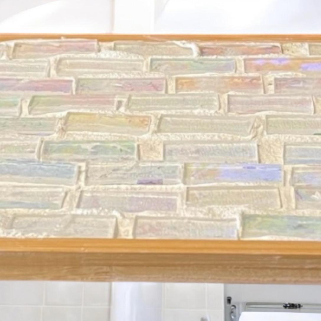 Rose quartz and slate mandala mosaic wall art featuring intricate geometric patterns and vibrant natural stone colors.