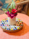 Colorful handcrafted polka dot rainbow mosaic plant stand with three legs, designed by Miss Bette's Creations.