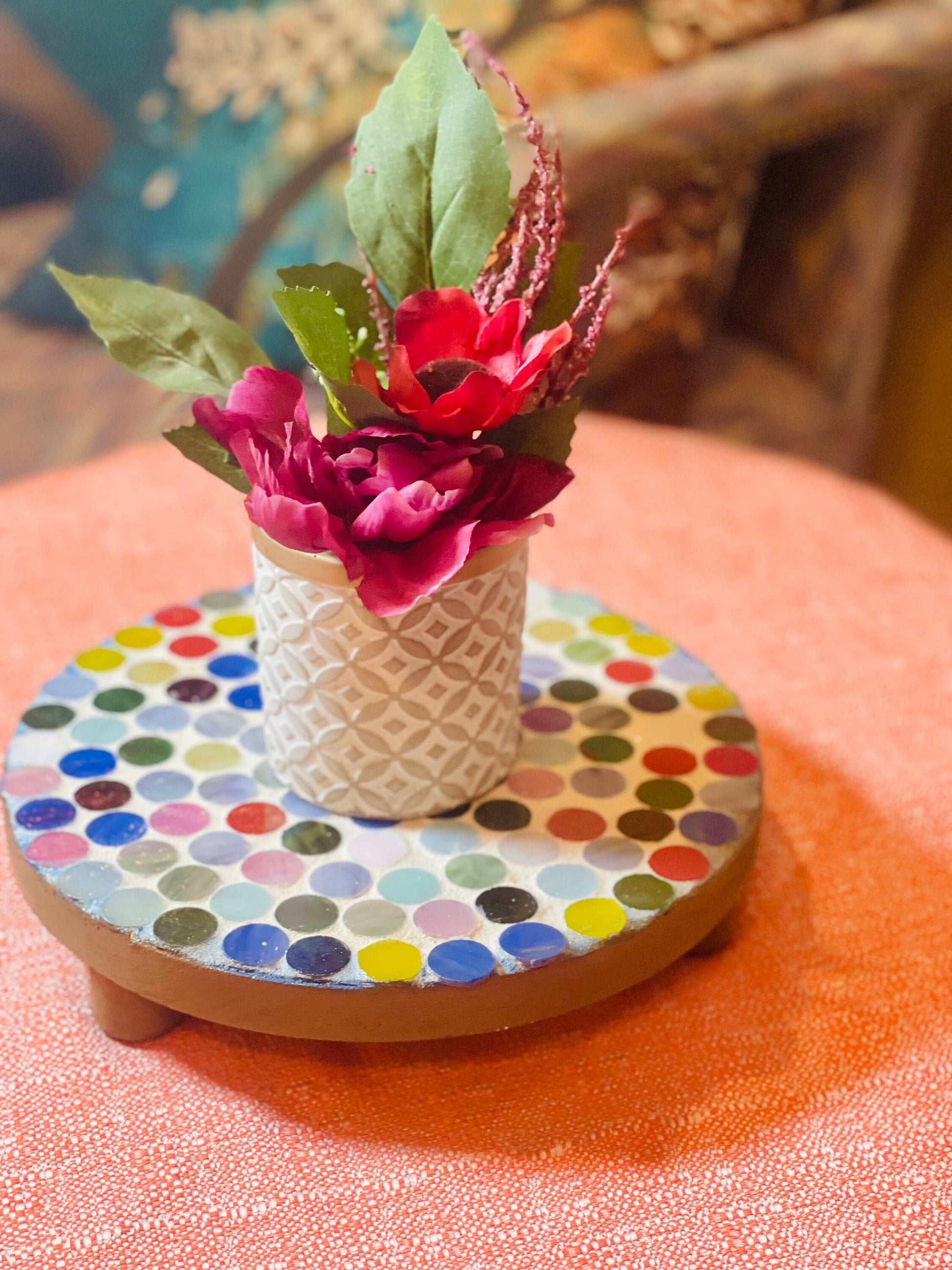 Colorful handcrafted polka dot rainbow mosaic plant stand with three legs, designed by Miss Bette's Creations.