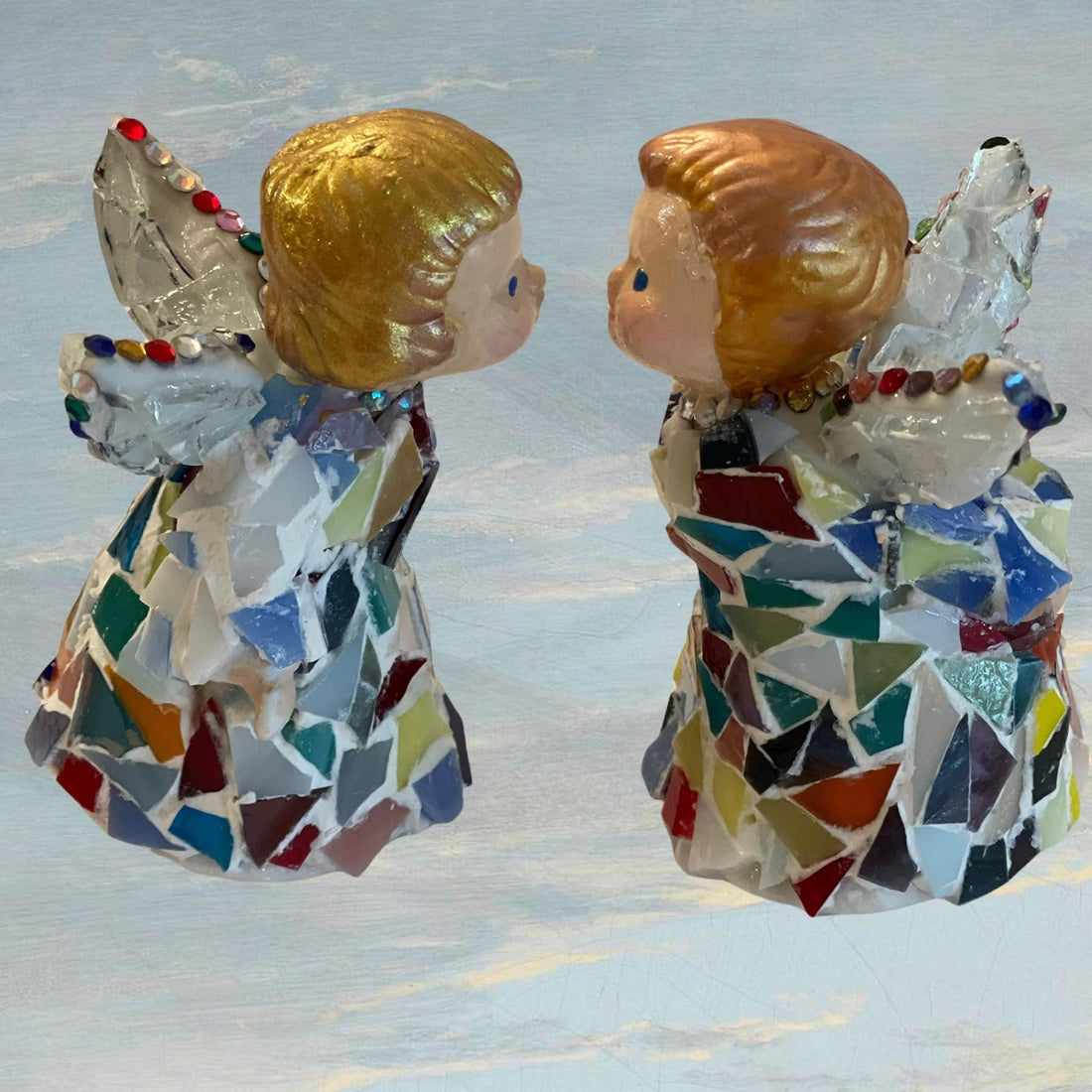 Handmade Christmas decor featuring two angel figurines with detailed wings and festive attire, perfect for holiday decoration.