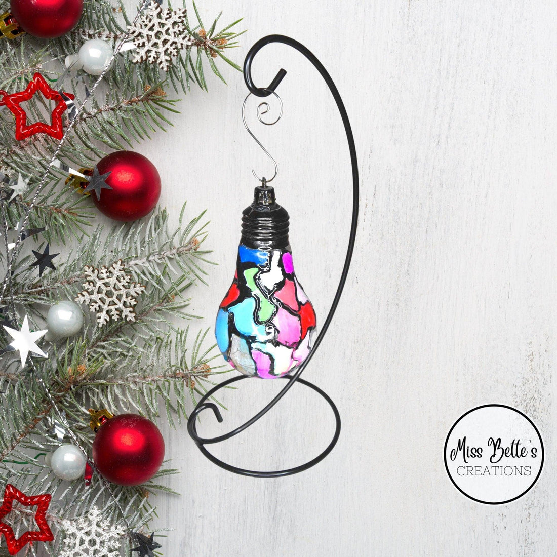 Handmade stained glass light bulb with mosaic design, holiday ornament featuring colorful, intricate glass patterns.