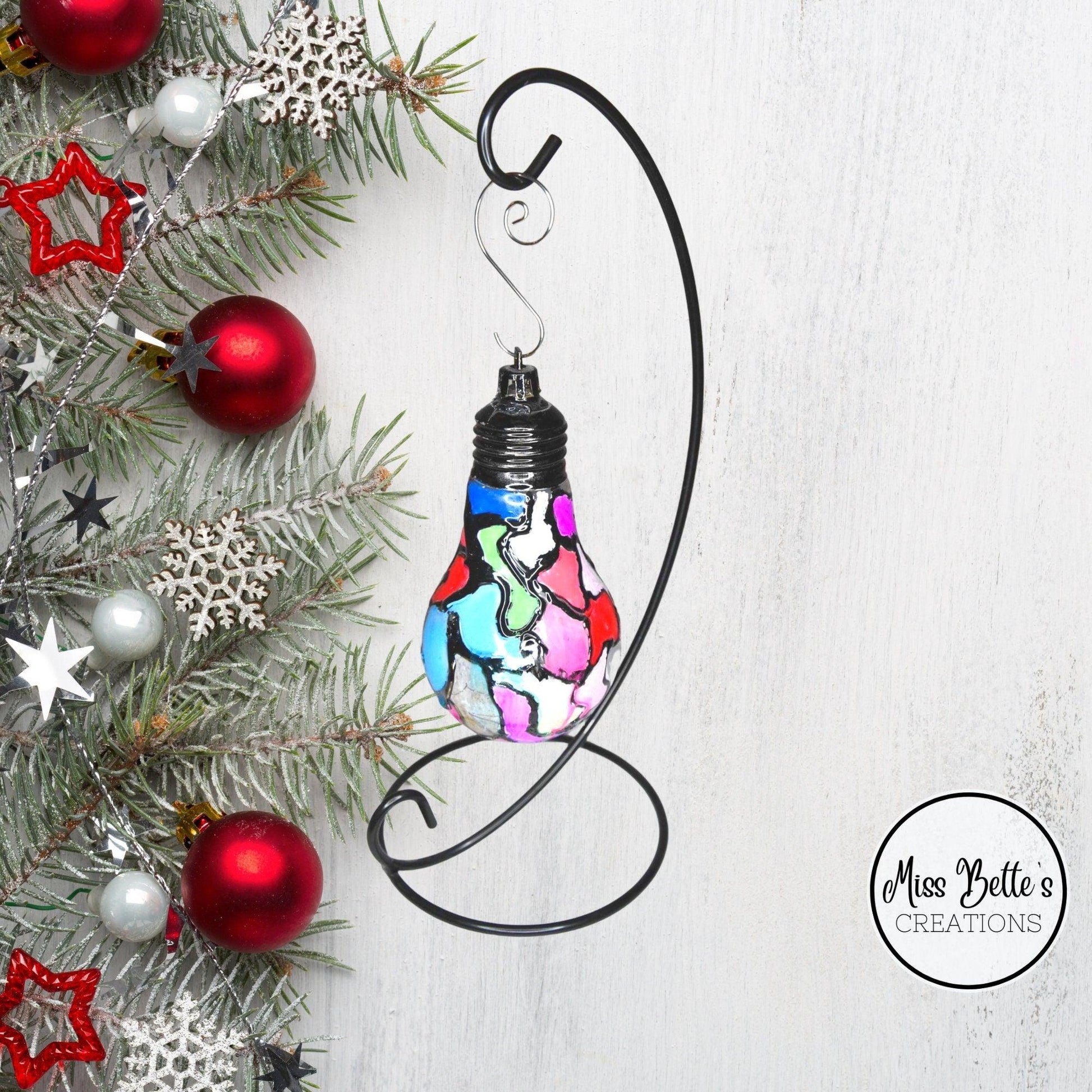 Handmade stained glass light bulb with mosaic design, holiday ornament featuring colorful, intricate glass patterns.