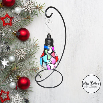 Handmade stained glass light bulb with mosaic design, holiday ornament featuring colorful, intricate glass patterns.