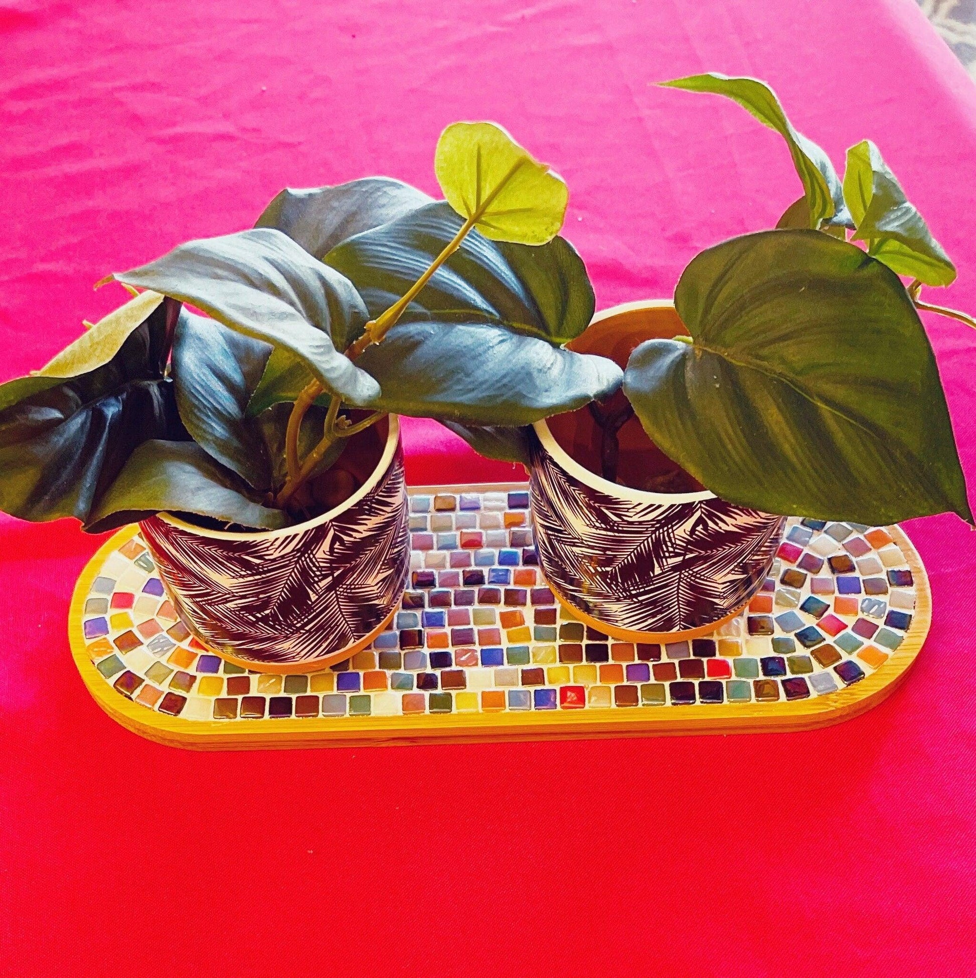 Ceramic trivet, spoon rest, or plant stand with decorative design, in neutral tones, suitable for kitchen or dining room use.
