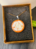 Artisan mosaic shell circle pendant featuring colorful shell inlay on a silver-toned metal frame, jewelry accessory.