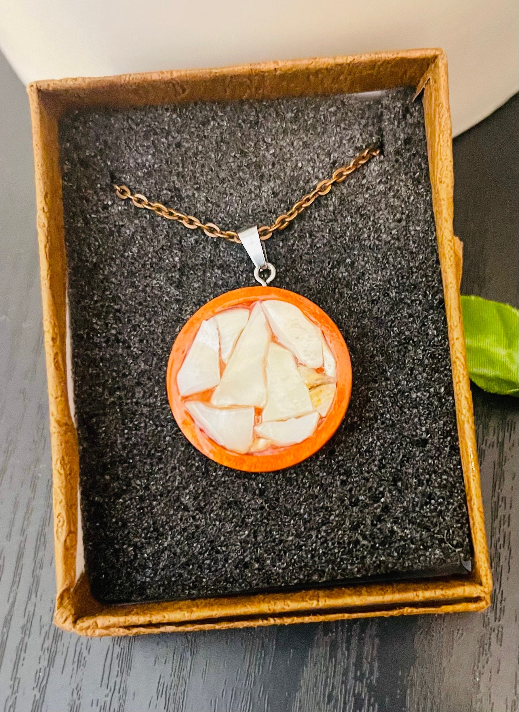 Artisan mosaic shell circle pendant featuring colorful shell inlay on a silver-toned metal frame, jewelry accessory.