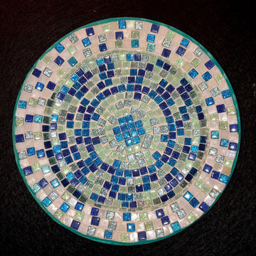 Iridescent turquoise mosaic glass wall art with vibrant, shimmering tiles arranged in an intricate pattern.