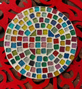 Handcrafted blue and amber mosaic plant stand with intricate tile design, ideal for displaying indoor or outdoor plants.