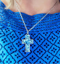Handcrafted crushed crystal cross necklace with silver chain, featuring sparkling crystal details and intricate design.