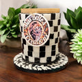 Handcrafted black and white checkerboard mosaic jar with intricate pattern, showcasing artistic craftsmanship and decorative design.
