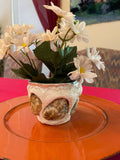 Handcrafted seashell and sandstone mini planter with natural textures, ideal for small plants or succulents.