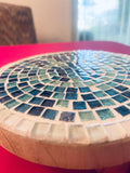 Handcrafted round turquoise glass mosaic plant riser with intricate tile pattern, perfect for elevating potted plants.