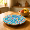 Colorful handcrafted round rainbow mosaic plant stand with multiple legs, perfect for displaying potted plants indoors or outdoors.
