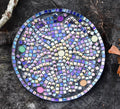 Handcrafted iridescent mosaic wall art with colorful glass pieces, showcasing intricate design and vibrant reflective surfaces.