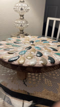 Handcrafted botanical petal mosaic plant stand with colorful floral design, made for supporting potted plants.