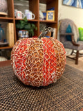 Handmade decorative fall pumpkin with orange and brown tones, perfect for autumn decor and seasonal display.