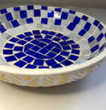 Blue and white stained glass bowl with intricate design, perfect for decorative or functional use.