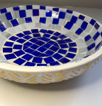 Blue and white stained glass bowl with intricate design, perfect for decorative or functional use.