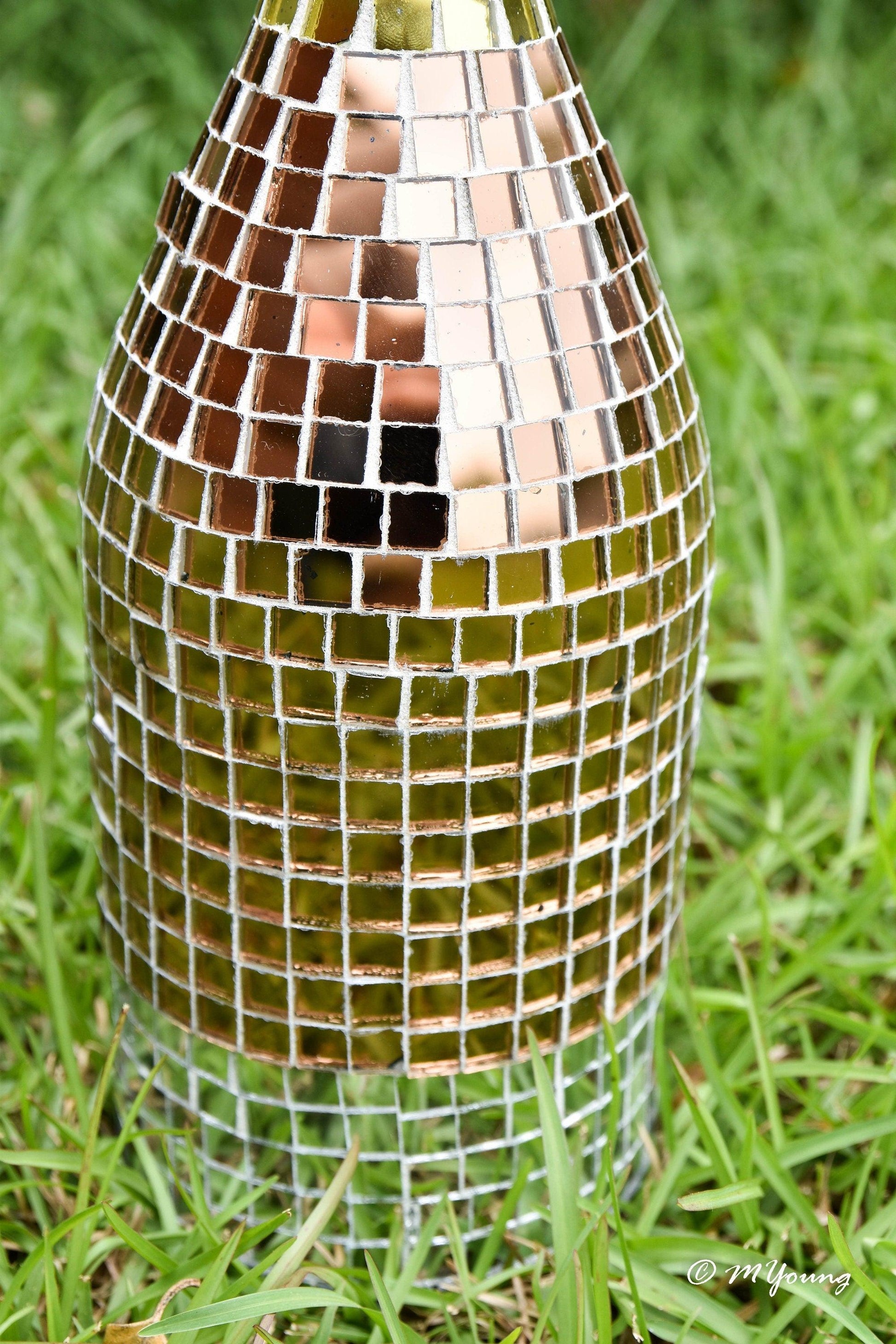 Luxury gold mosaic wine decanter with intricate gold and glass design, perfect for elegant wine serving.
