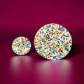 Colorful handcrafted round rainbow mosaic plant stand with intricate tile design, perfect for displaying potted plants.