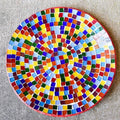 Colorful handcrafted rainbow mosaic stepping stone with intricate tile patterns for garden or pathway decoration.