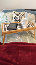 Rustic bamboo bed tray with stone mosaic inlay, featuring handles and sturdy construction for breakfast or serving at home.