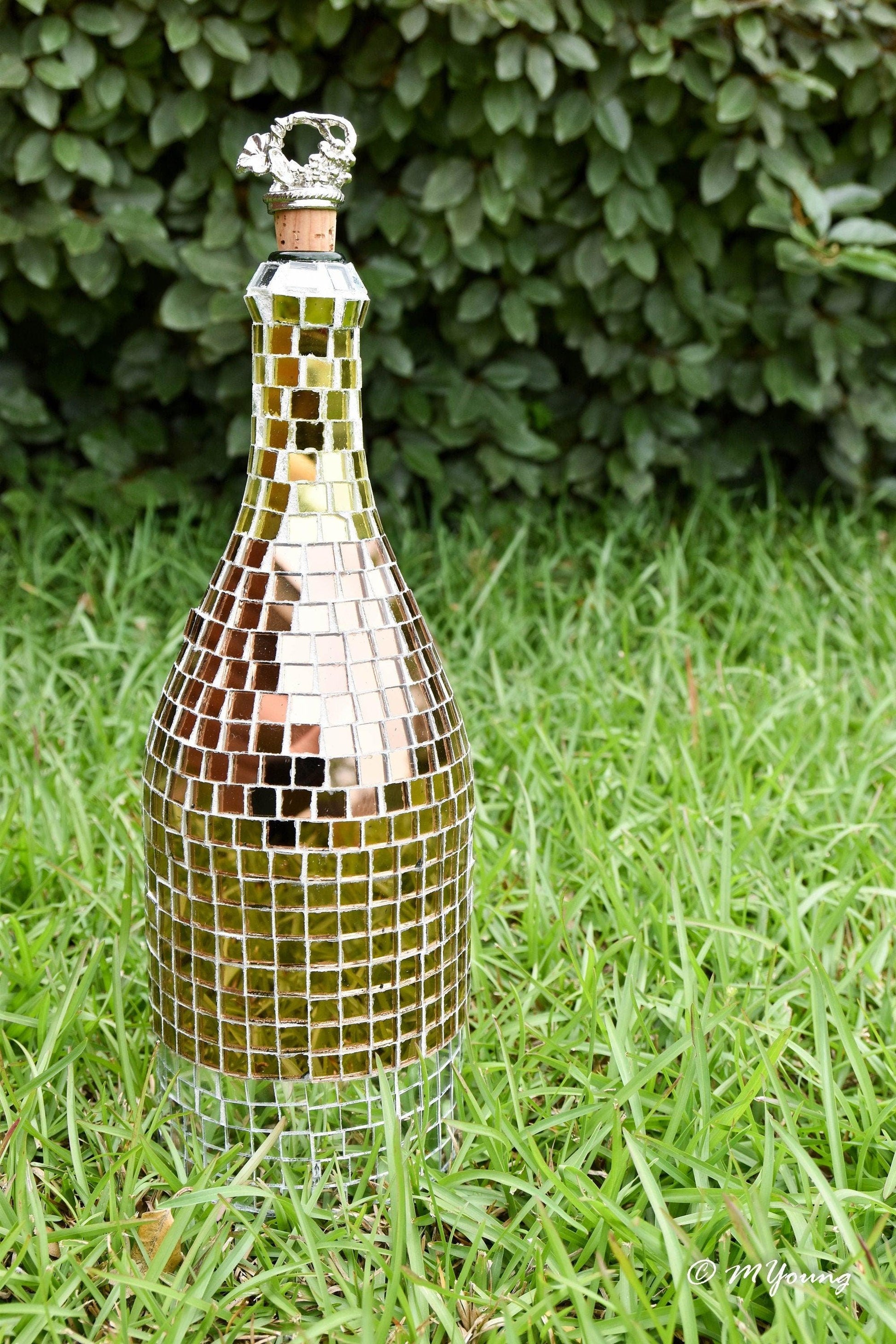 Luxury gold mosaic wine decanter with intricate gold pattern and clear glass body for elegant wine serving.
