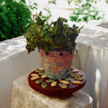 Handcrafted petal mosaic wooden plant stand featuring colorful petal patterns, ideal for displaying potted plants indoors or outdoors.