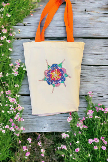 Handmade sparkling starburst diamond art canvas tote bag with colorful geometric design and sturdy fabric handles.