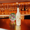 Handcrafted glass carafe with shell design and decorative bottle stopper by Miss Bette's Creations, featuring elegant glass craftsmanship.