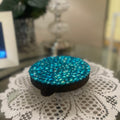 Artisanal turquoise cabochon mosaic plant stand by Miss Bette's Creations, featuring colorful mosaic tile design and sturdy base.