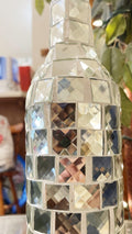 Silver mirrored mosaic wine decanter with geometric design and elegant shape, showcasing reflective surface and decorative craftsmanship.