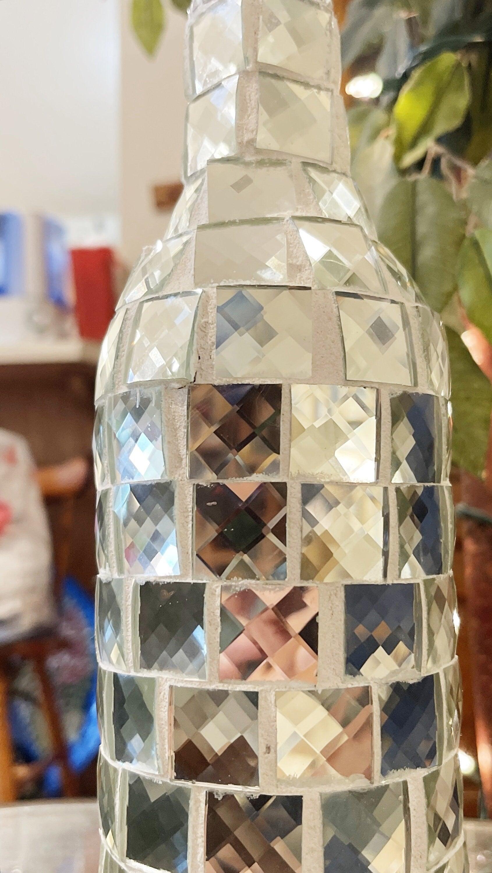 Silver mirrored mosaic wine decanter with geometric design and elegant shape, showcasing reflective surface and decorative craftsmanship.