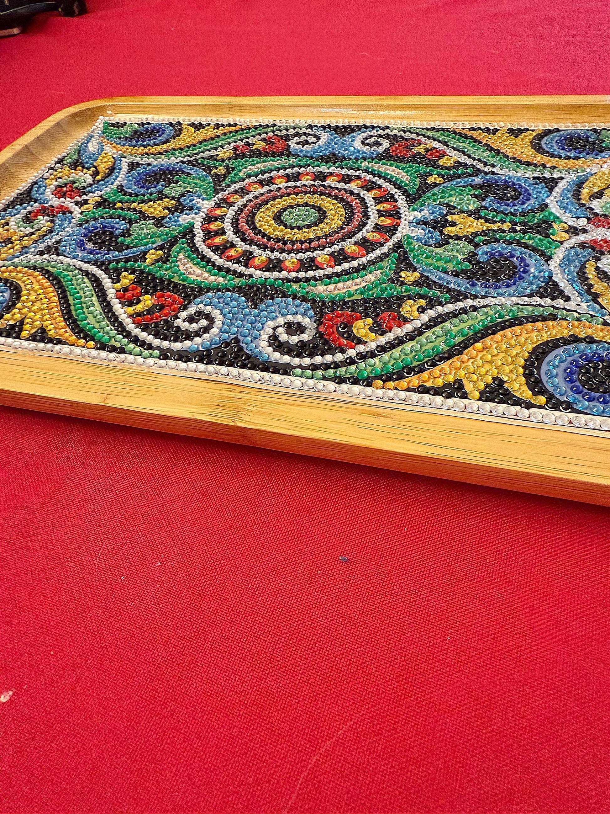 Handcrafted diamond art bamboo serving tray with intricate designs, natural wood finish, and handles for serving or display.