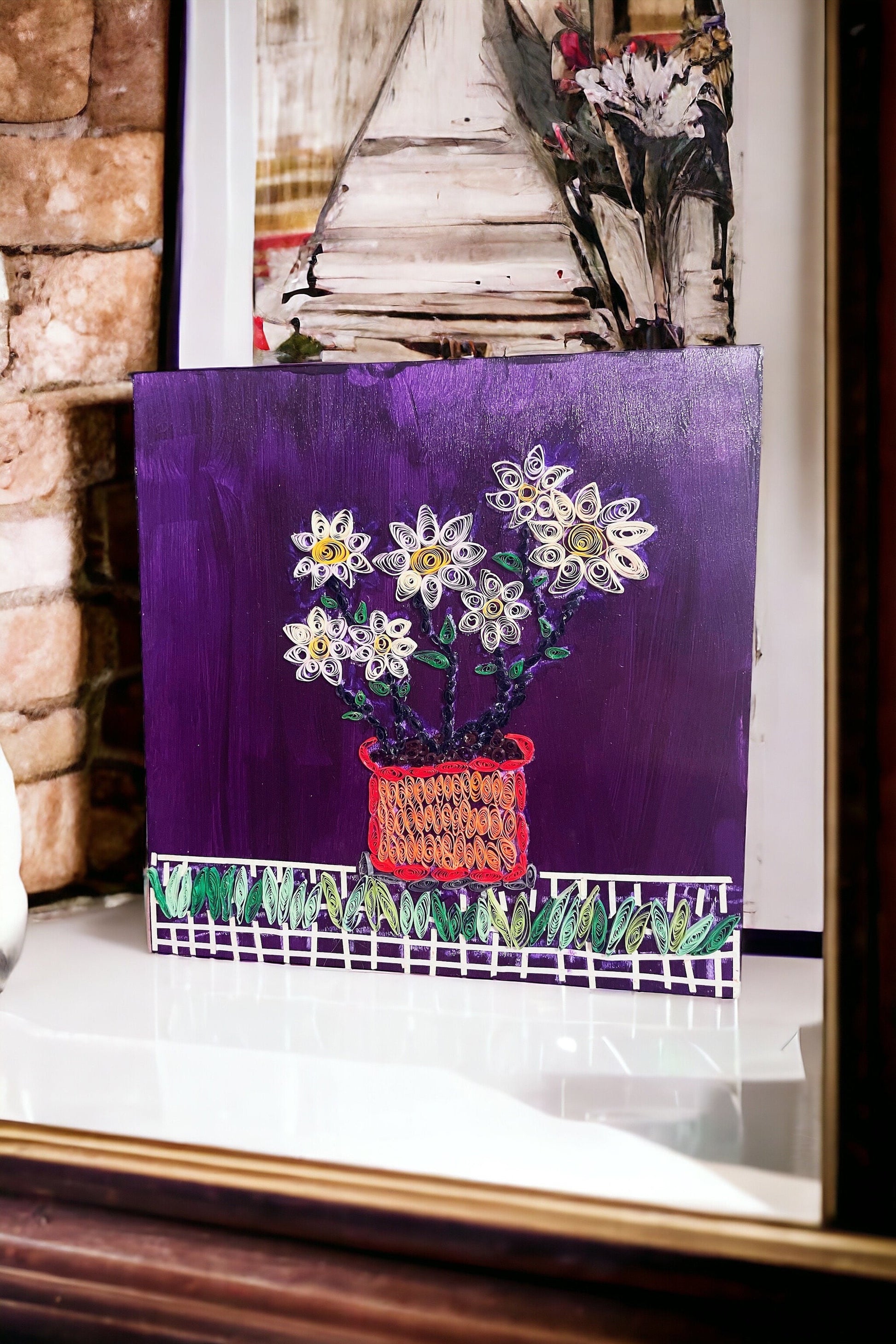 Original paper quilling art of a flower pot, showcasing intricate paper designs and vibrant colors in a detailed floral artwork.