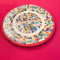 Colorful handcrafted mosaic fruit bowl featuring vibrant geometric patterns, perfect for decorative or functional use.