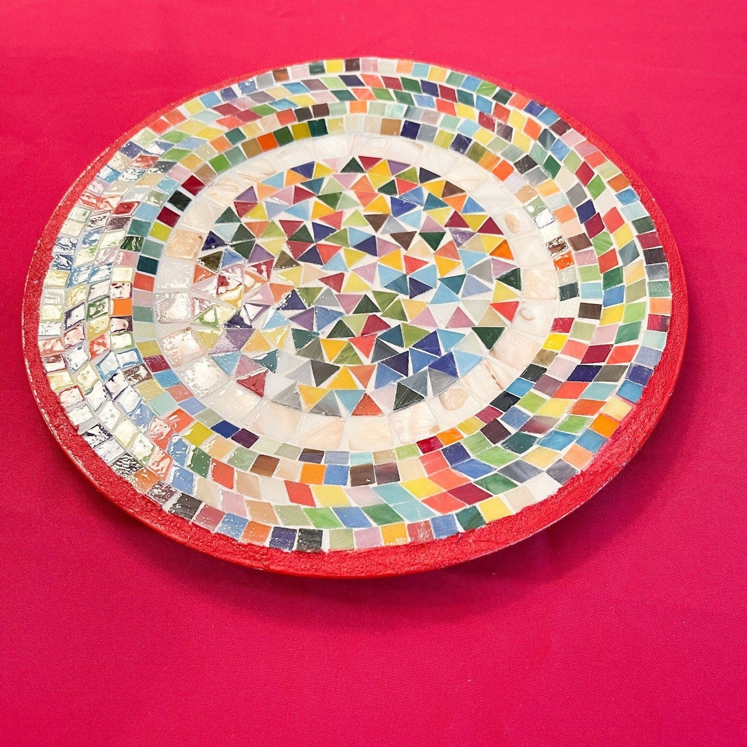 Colorful handcrafted mosaic fruit bowl featuring vibrant geometric patterns, perfect for decorative or functional use.