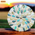 Handcrafted botanical petal mosaic plant stand with colorful floral design for indoor or outdoor decor.