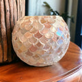 Handcrafted scalloped Capiz shell globe vase with intricate shell details and a rounded shape, ideal for elegant home decor.